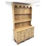 Waxed pine dresser with plate stand, projecting cornice, two shelves above six short drawers, dresse