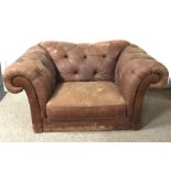Snuggle armchair upholstered in a deep buttoned chocolate fabric