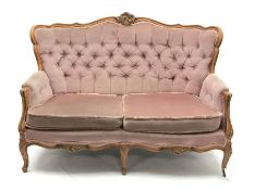 20th century beech framed French style two seat settee, the shaped and moulded frame carved with fol