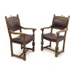 Pair 20th century oak armchairs, shaped cresting rail carved with flower heads, dished seats and bac