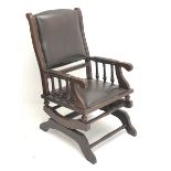 19th century mahogany framed American rocking armchair, seat, back and arms upholstered in brown stu