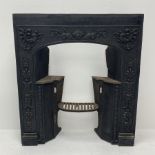 19th century black painted cast iron fire inset, decorated with central shell and scrolled foliate,