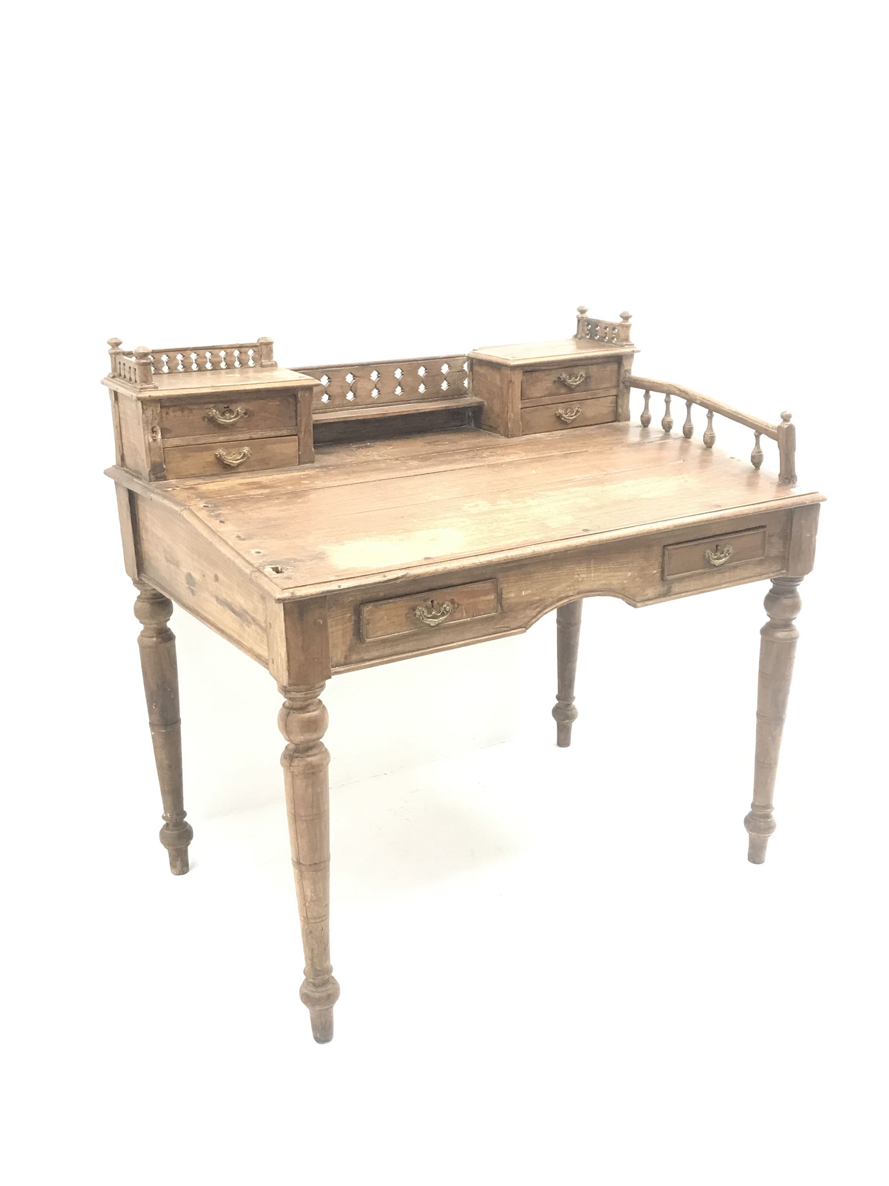 Eastern hardwood clerks desk, raised back with pierced gallery, four small drawers above sloping fro