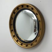 20th century circular gilt wall mirror with convex glass, moulded black lacquered slip and mounted b