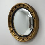 20th century circular gilt wall mirror with convex glass, moulded black lacquered slip and mounted b