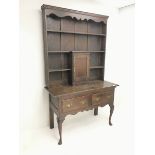Early 20th century oak dresser, raised three tier plate rack, single cupboard above two drawers, cab