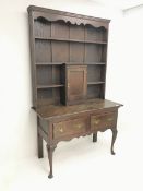 Early 20th century oak dresser, raised three tier plate rack, single cupboard above two drawers, cab