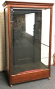 Large early 20th century mahogany framed glazed display, projecting cornice, single door, W132cm, H2