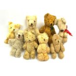 Eight 1950s European small teddy bears including a German one with open mouth