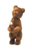 'Meabeab' Russian clockwork plush covered bear c1950s depicted standing with open mouth holding an i