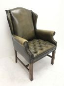 Georgian style wing back armchair upholstered in deep buttoned and studded green leather