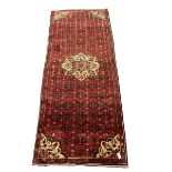 Persian red ground runner rug