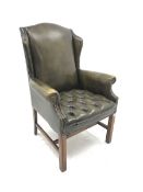 Georgian style wing back armchair upholstered in deep buttoned and studded green leather