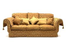 Grande three seat sofa upholstered in red and gold damask fabric with complimentary cushions