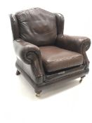 Thomas Lloyd wing back armchair upholstered in a brown leather
