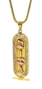 Gold Egyptian pendant depicting hieroglyphs