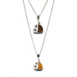 Two silver Baltic amber boat pendant necklaces; one orange and the other green coloured amber