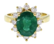 Gold oval emerald and diamond cluster ring