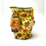 An early 19th century Staffordshire canary yellow Satyr mask jug