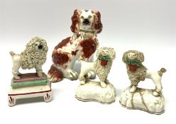 A pair of Victorian Staffordshire figures modelled as poodles