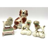 A pair of Victorian Staffordshire figures modelled as poodles