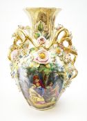 A large Continental vase, of ovoid form with naturalistic modelled twin gilt handles, decorated with
