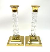 A pair of Waterford lead crystal cut glass and brass mounted candlesticks