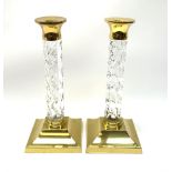 A pair of Waterford lead crystal cut glass and brass mounted candlesticks