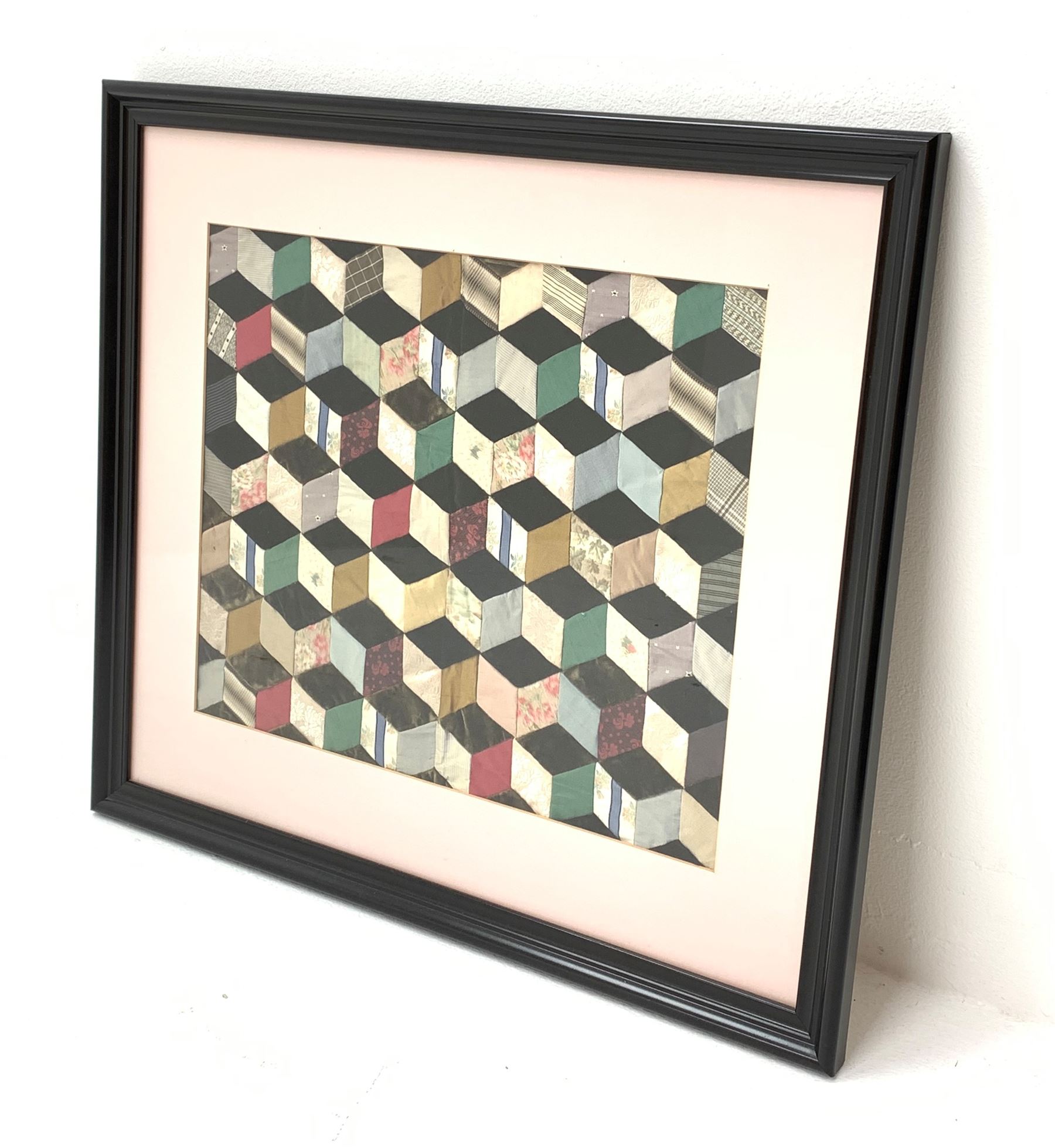 A framed and glazed geometric patchwork section