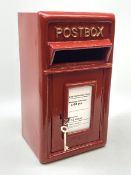 A reproduction red painted cast iron Postbox