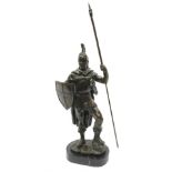 A bronzed figure modelled as a warrior