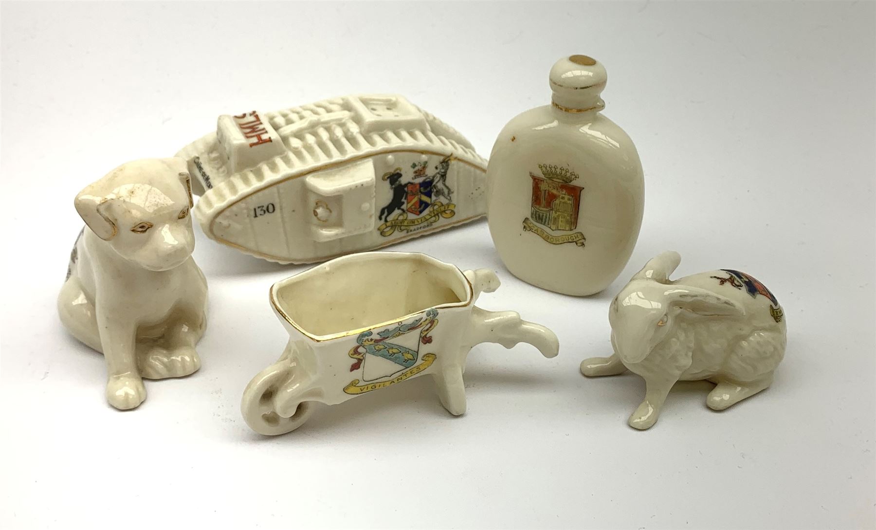 A Carlton china crested moneybox modelled as a tank with shield armorial for Bradford