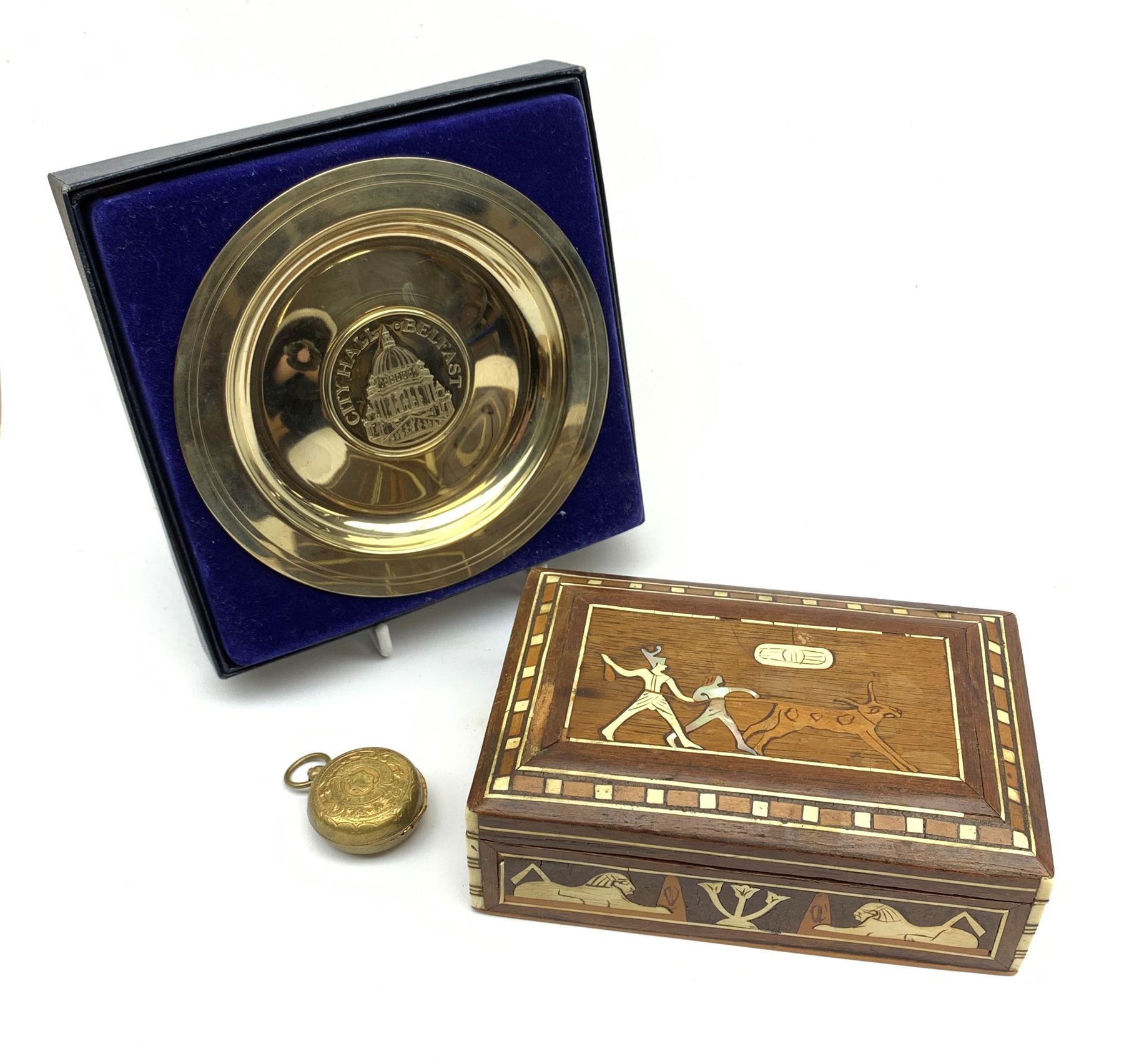 An Egyptian inlaid hardwood box; boxed Belfast City Hall souvenir dish; and incomplete gilt brass so