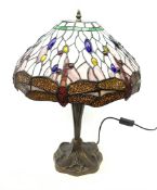Tiffany style table lamp, with cast spreading base detailed with flowers, and leaded glass shade det