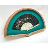 Framed oriental fan with mother-of-pearl sticks and guards and black cloth fan