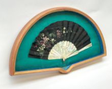 Framed oriental fan with mother-of-pearl sticks and guards and black cloth fan