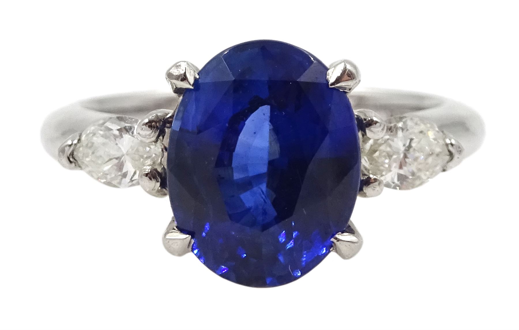 Platinum oval Ceylon sapphire and marquise shape diamond three stone ring