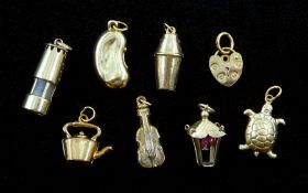 Eight 9ct gold charms including tortoise