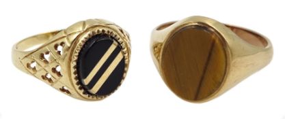 Gold black onyx signet ring and one other set with a tigers eye