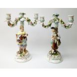 A pair of Continental two branch candlesticks