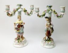 A pair of Continental two branch candlesticks