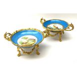 A pair of early 20th century Sevres style ormolu mounted twin handled tazzas