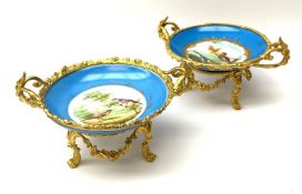 A pair of early 20th century Sevres style ormolu mounted twin handled tazzas