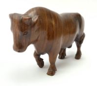 Ann Baxter (British b. 1969): a carved wooden model of a Bull