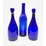 A pair of early 19th century Bristol blue glass decanters with teardrop stoppers