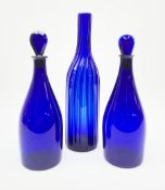 A pair of early 19th century Bristol blue glass decanters with teardrop stoppers