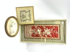 A framed and glazed micro beadwork panel depicting cherubs and a fruiting and flowering vine
