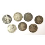 Seven early milled shilling coins