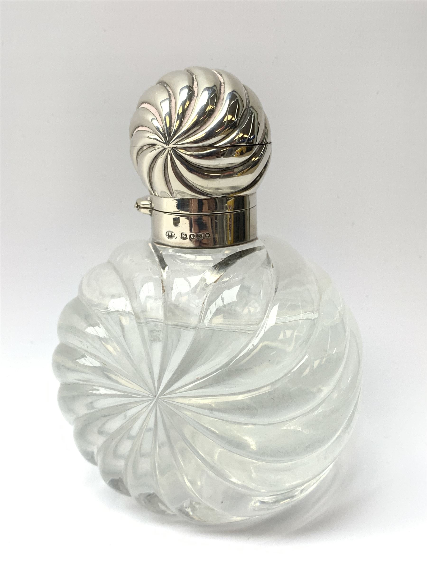 Victorian cut glass scent bottle with silver wrythen fluted top and conforming body
