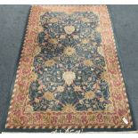 Blue ground rug overall foliate design with stylised leaf motifs within multiple border